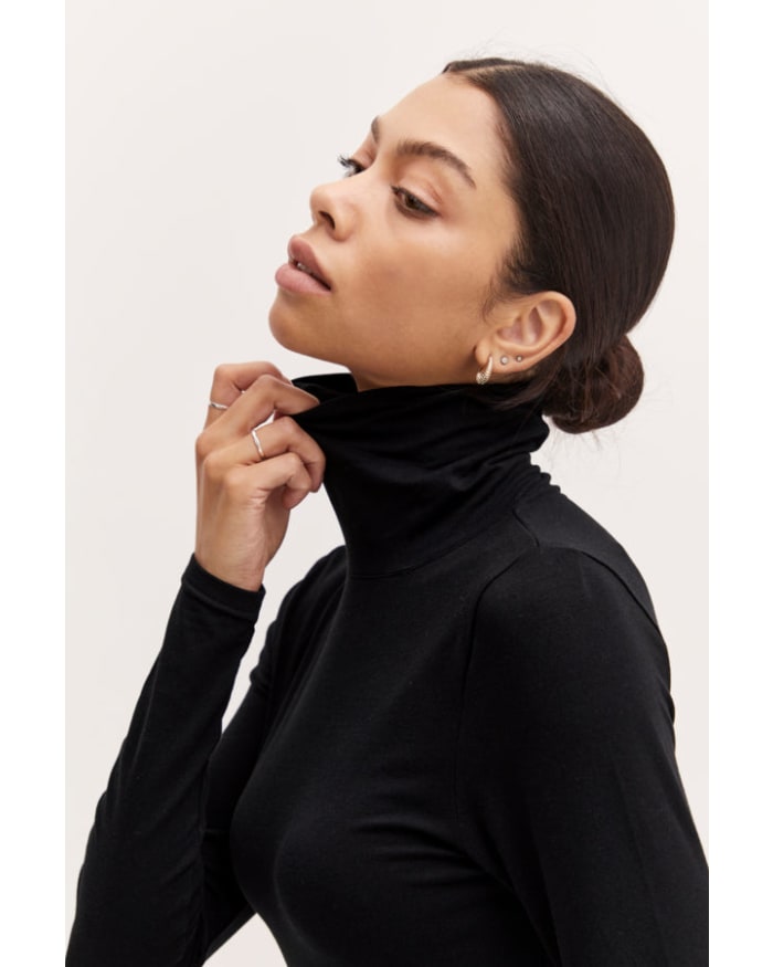 a woman in a black turtleneck