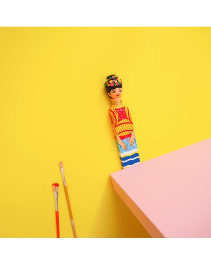 a painting brush next to a pink table