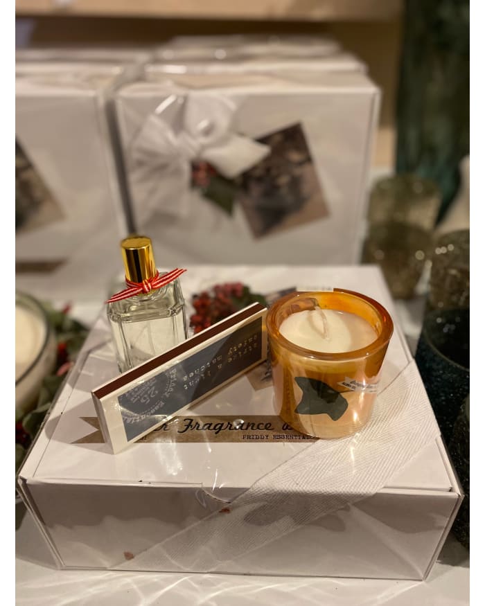 a white box with a candle and a candle on it
