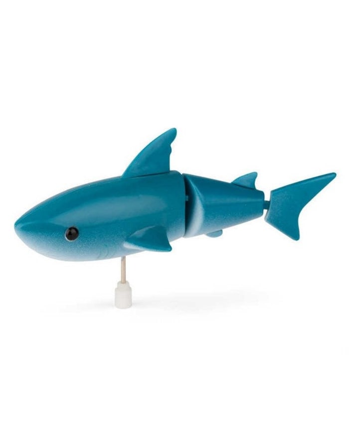 a blue toy shark on a white background