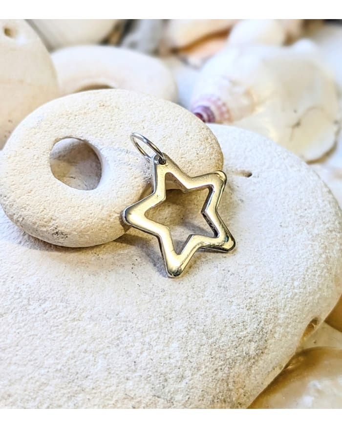 a star shaped pendant on rocks