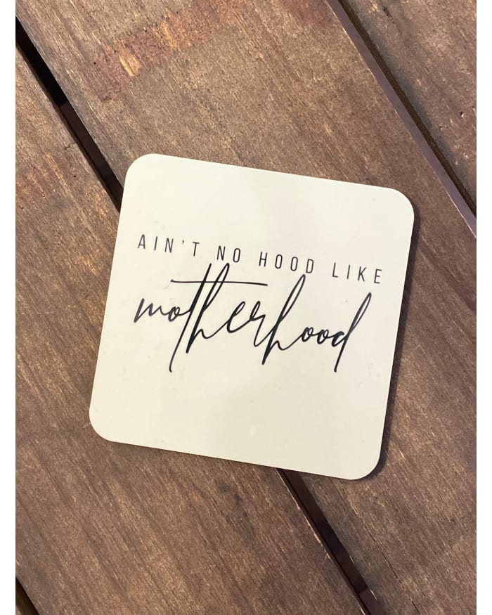 a square white coaster with black text on it