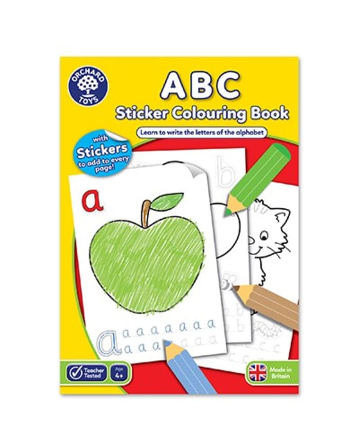 a book with a green apple and pencils