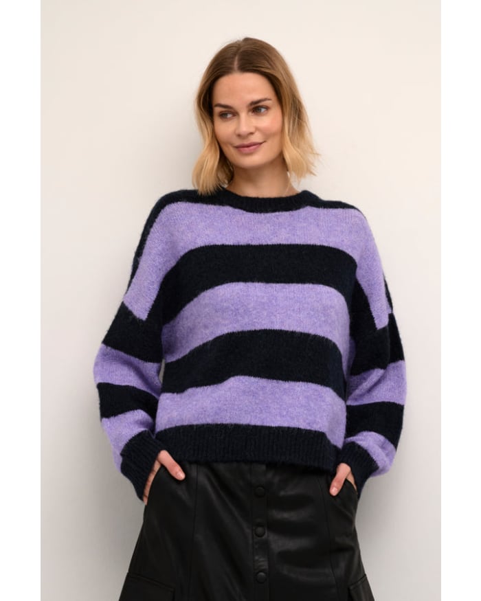 a woman in a purple and black striped sweater