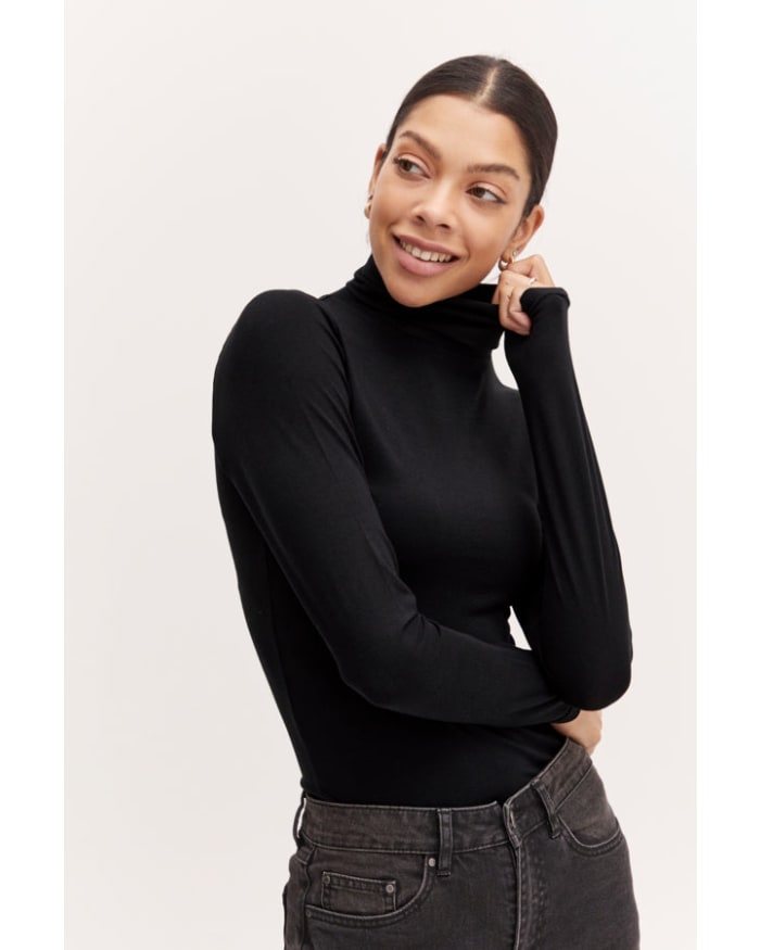 a woman in a black turtleneck