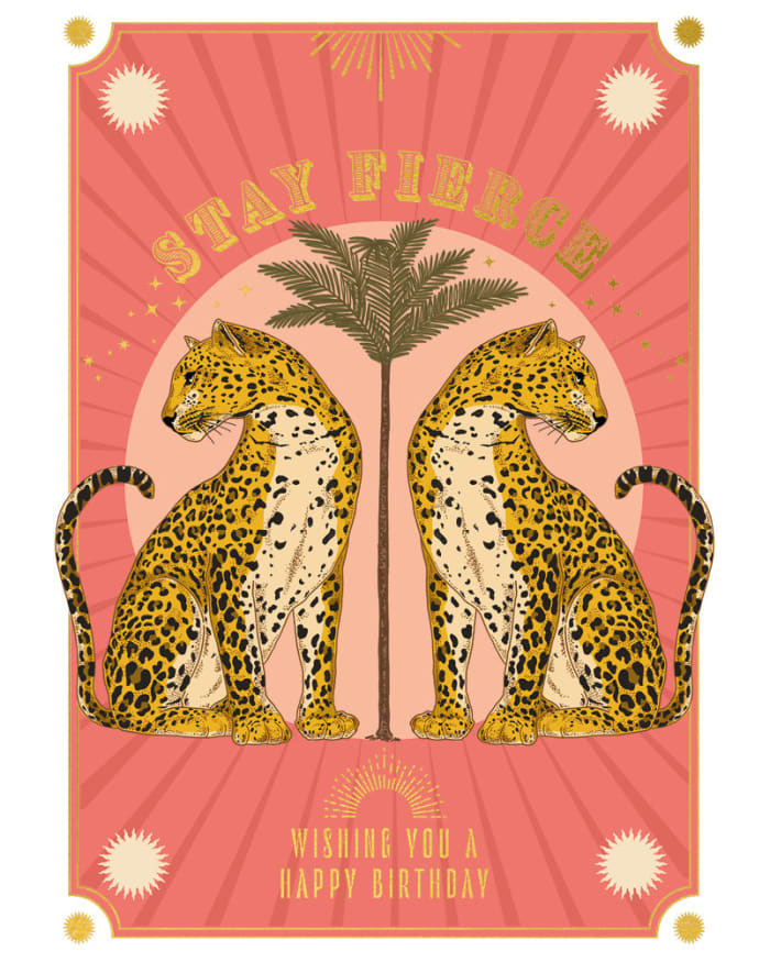 two cheetahs sitting next to a palm tree