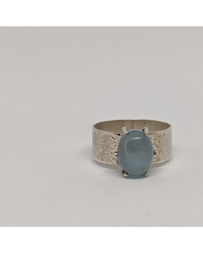 a silver ring with a blue stone