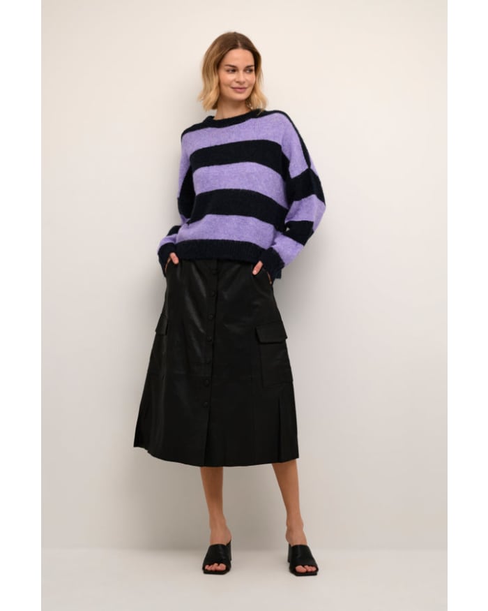 a woman in a purple and black striped sweater