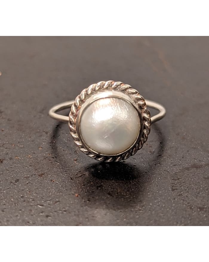 a ring with a pearl in it