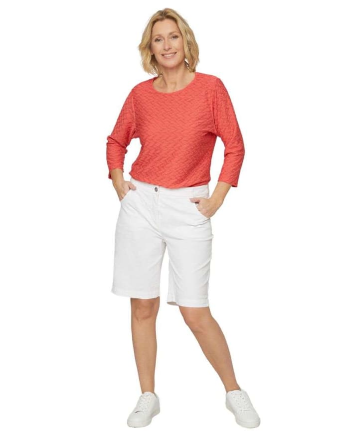 a woman in white shorts and red shirt