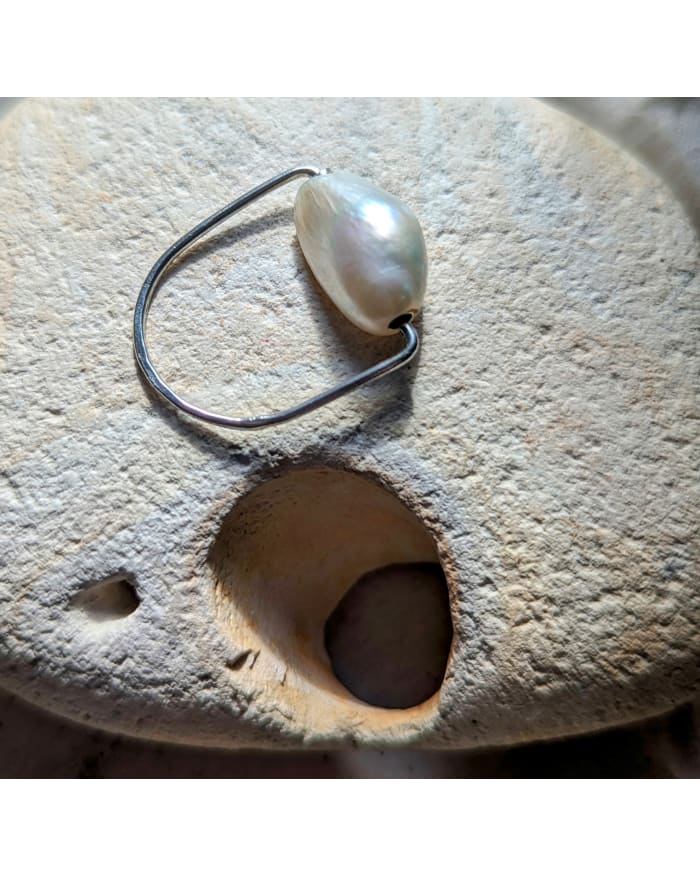 a pearl necklace on a rock