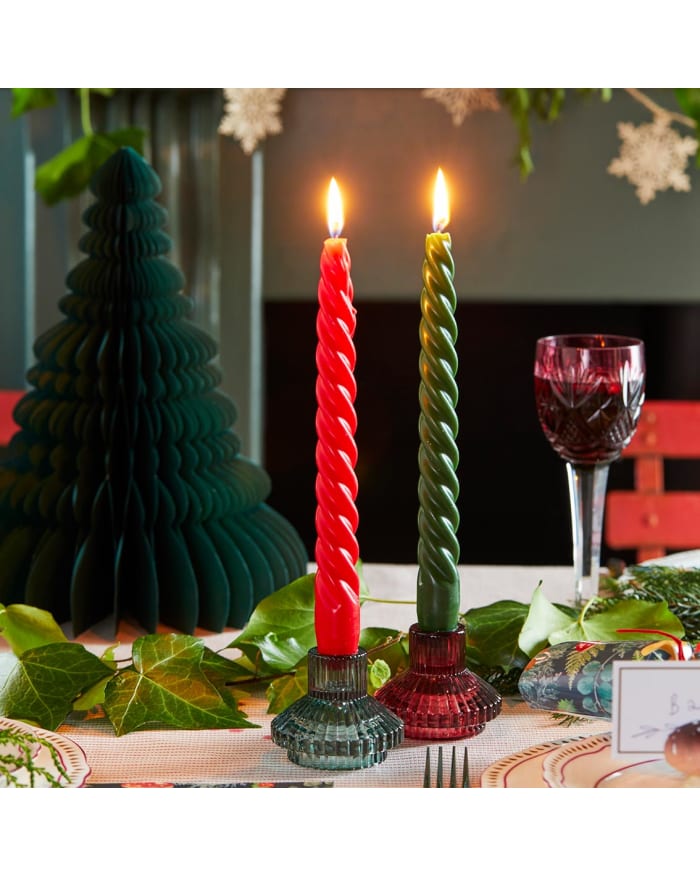 a red and green candles on a table