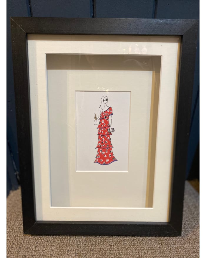 a framed picture of a woman in a red dress