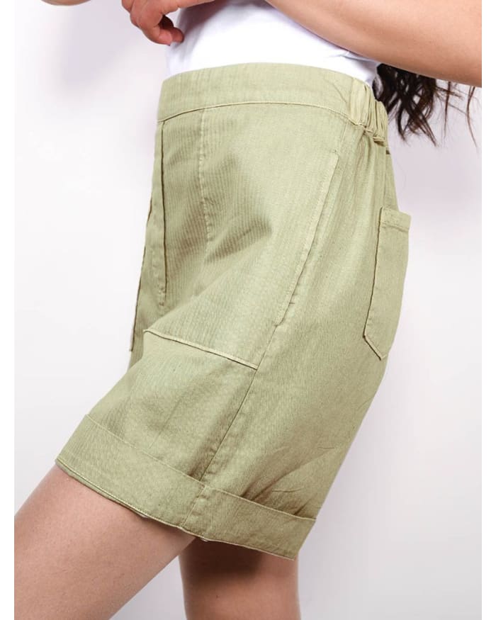 a woman wearing a green shorts