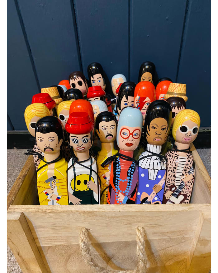 a group of Wedgie Doorstops in a wooden box