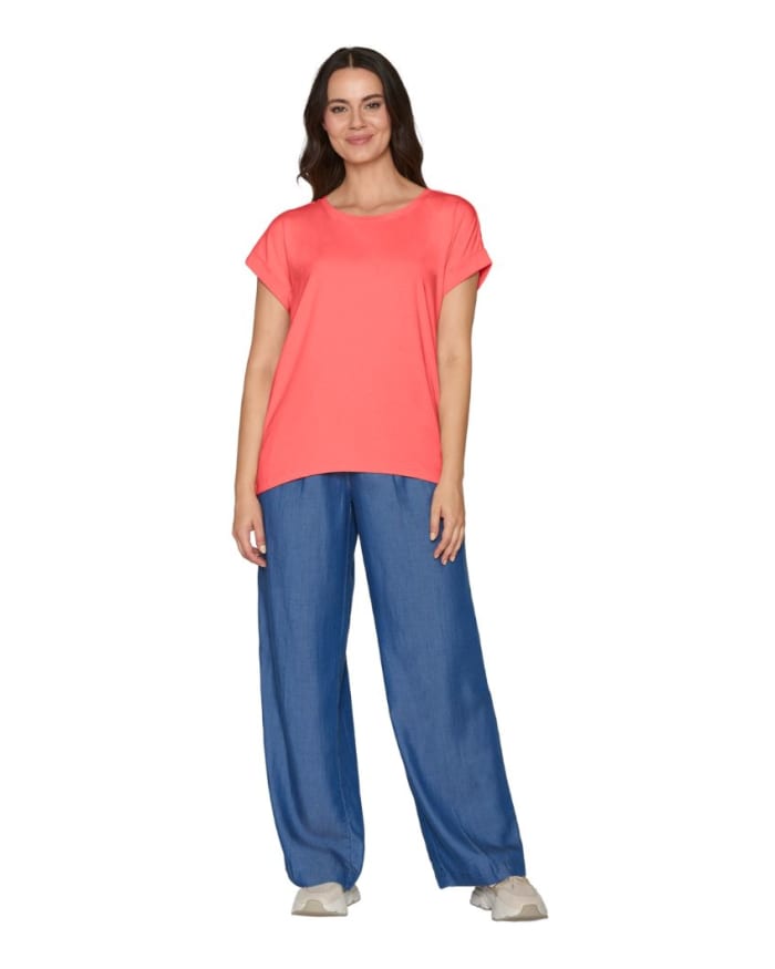 a woman in a pink shirt and blue pants