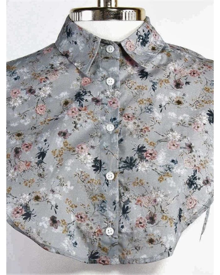 a grey floral shirt with white buttons