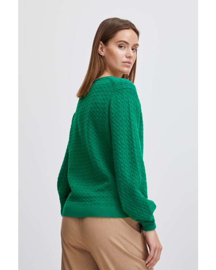 a woman in a green sweater