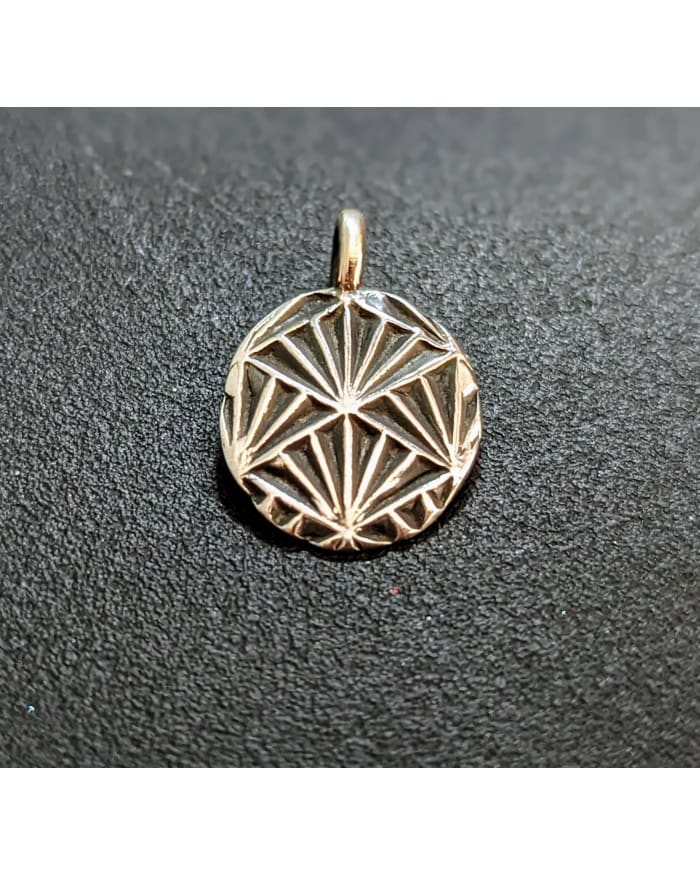 a gold medallion with a diamond design