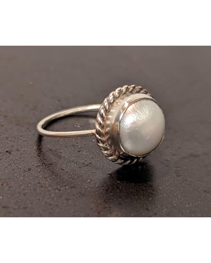 a ring with a pearl in it