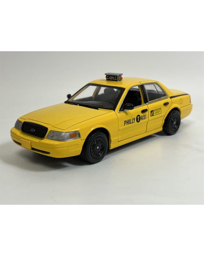 a yellow taxi car on a white surface