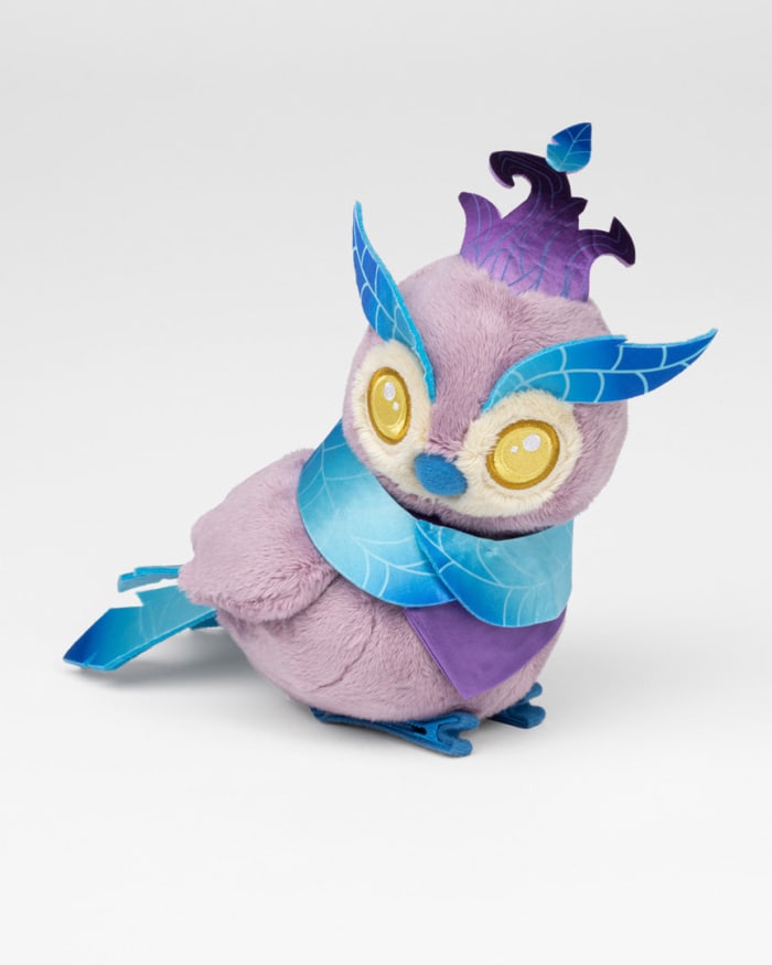 a purple stuffed animal with blue and purple feathers