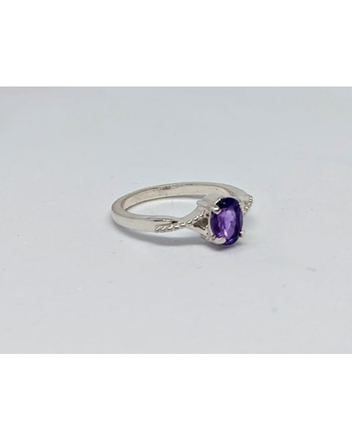 a silver ring with a purple stone