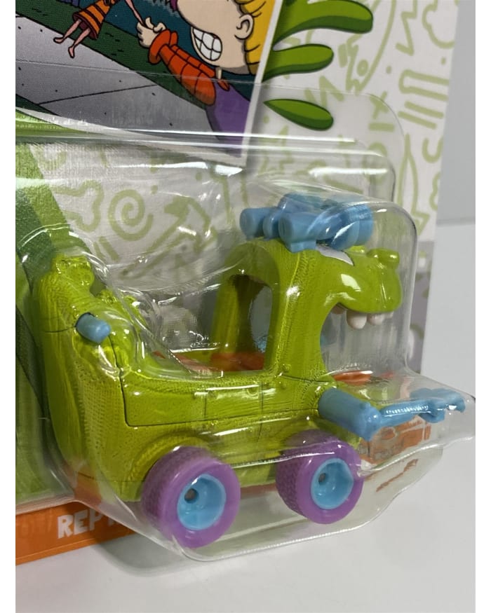 a green toy car in a plastic wrap