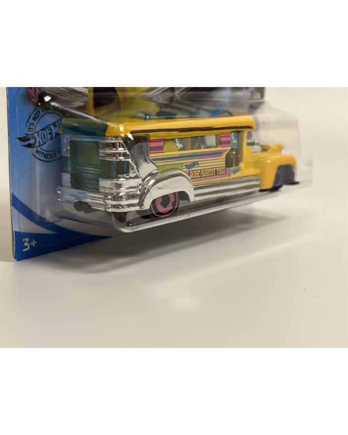 a yellow toy vehicle in a plastic package