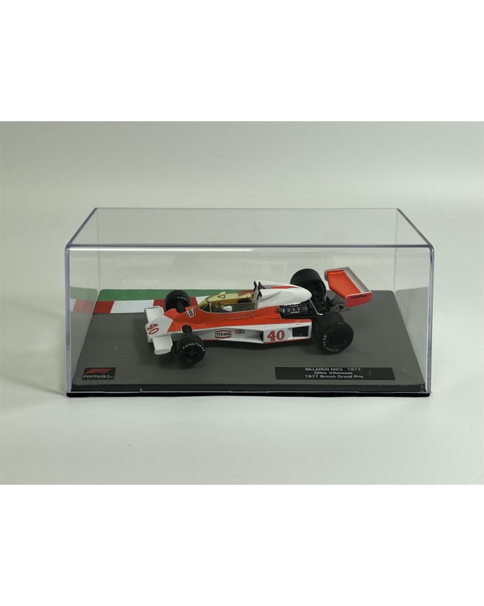 a toy race car in a glass case