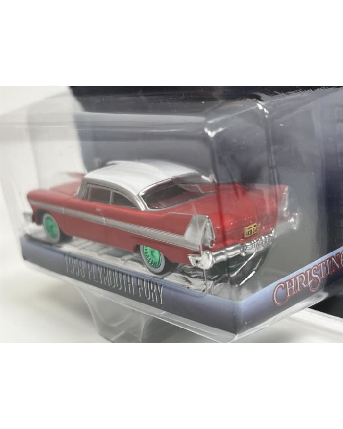 a red and white toy car in a plastic package