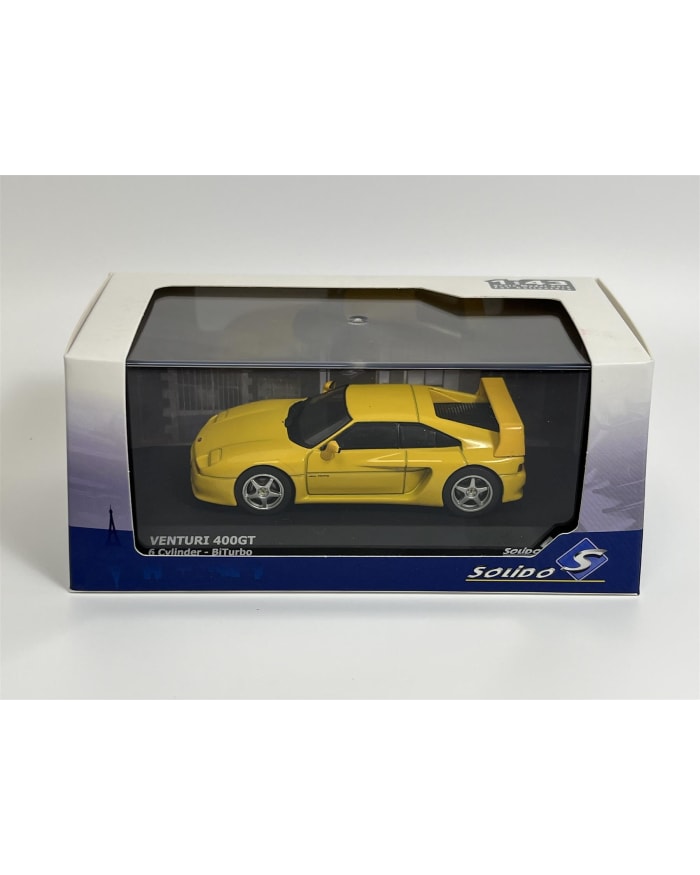 a yellow toy car in a box