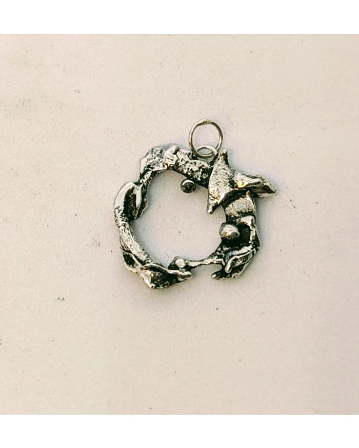 a silver circle with a ring on it