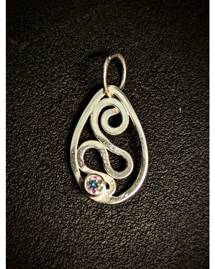 a silver pendant with a colorful gem