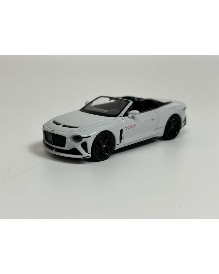 a white toy car on a white surface