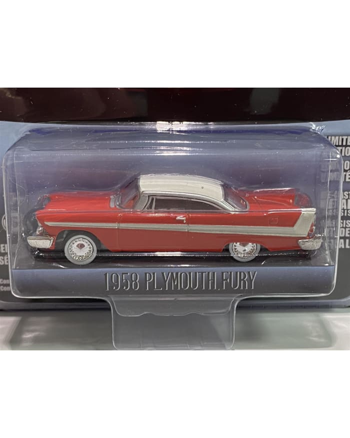 a red and white toy car in a plastic package