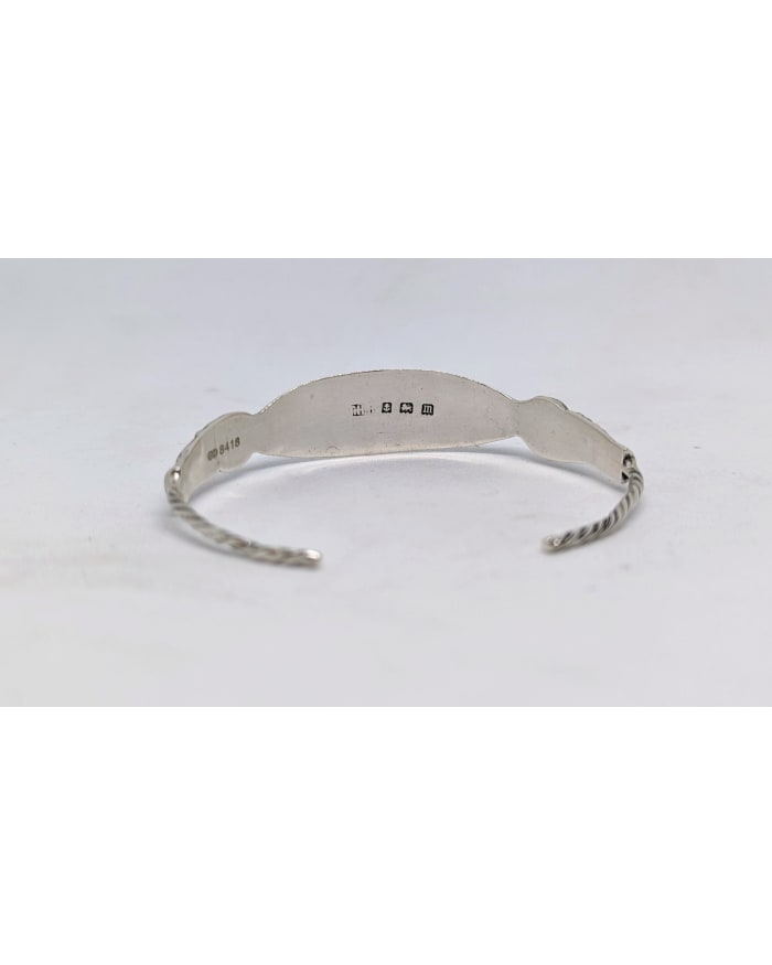 a silver bracelet with a silver band