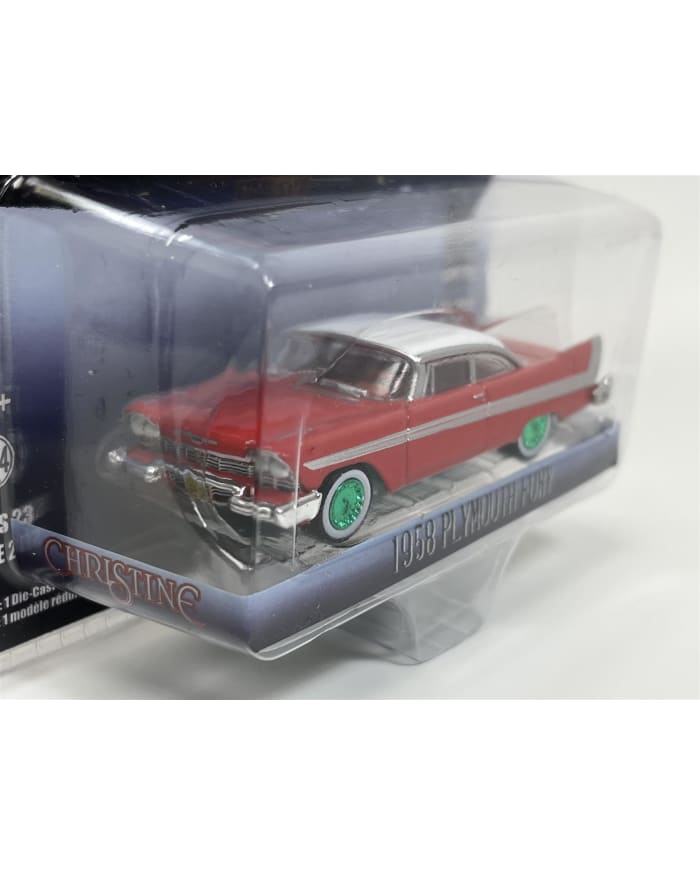 a red and white toy car in a plastic box