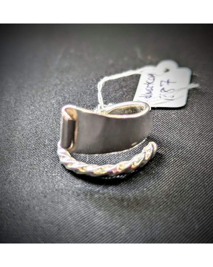a silver ring with a tag