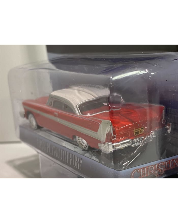 a red and white toy car in a plastic package