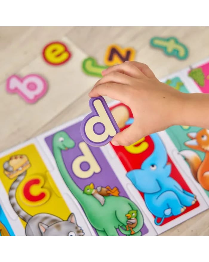 a child's hand holding a letter