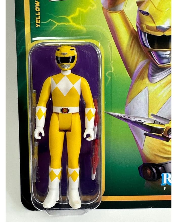 a yellow action figure in a package