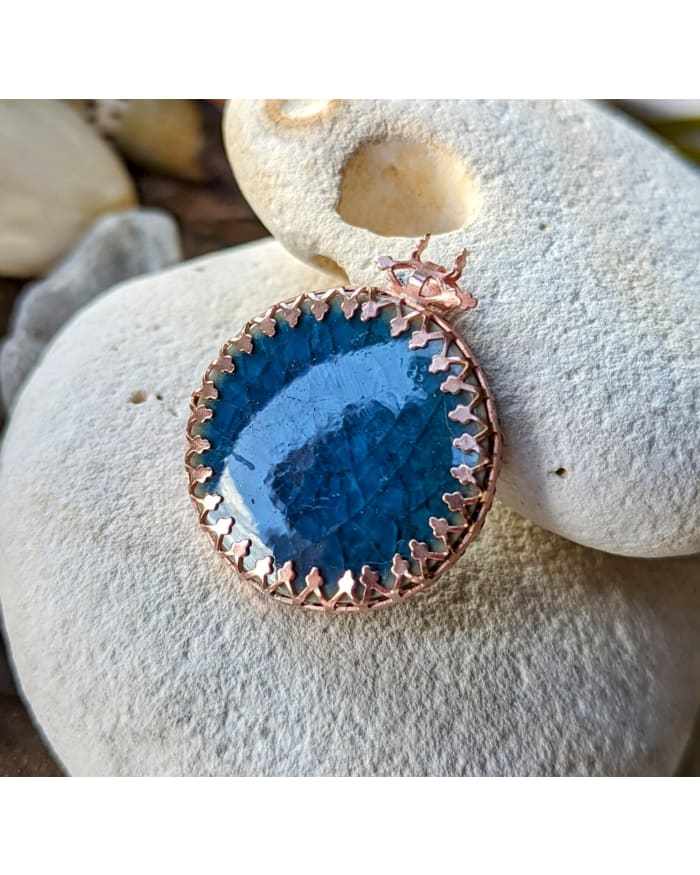 a blue stone with a gold border on top of it