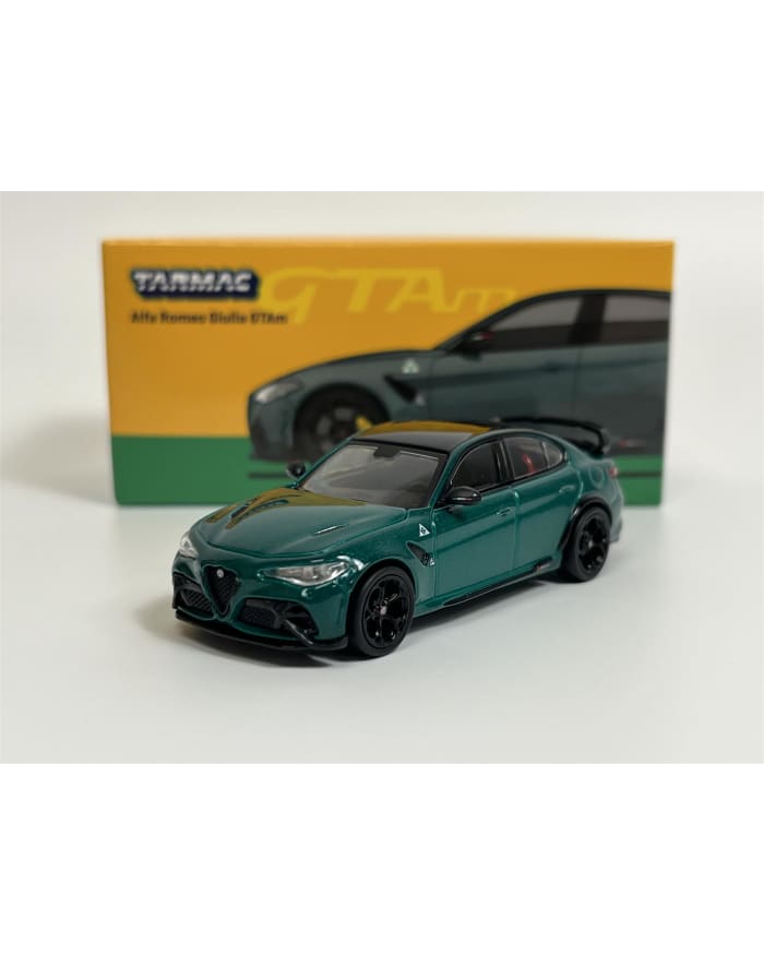 a green toy car next to a box