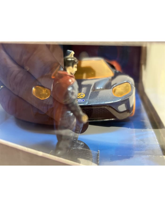 a toy car and figurine in a case