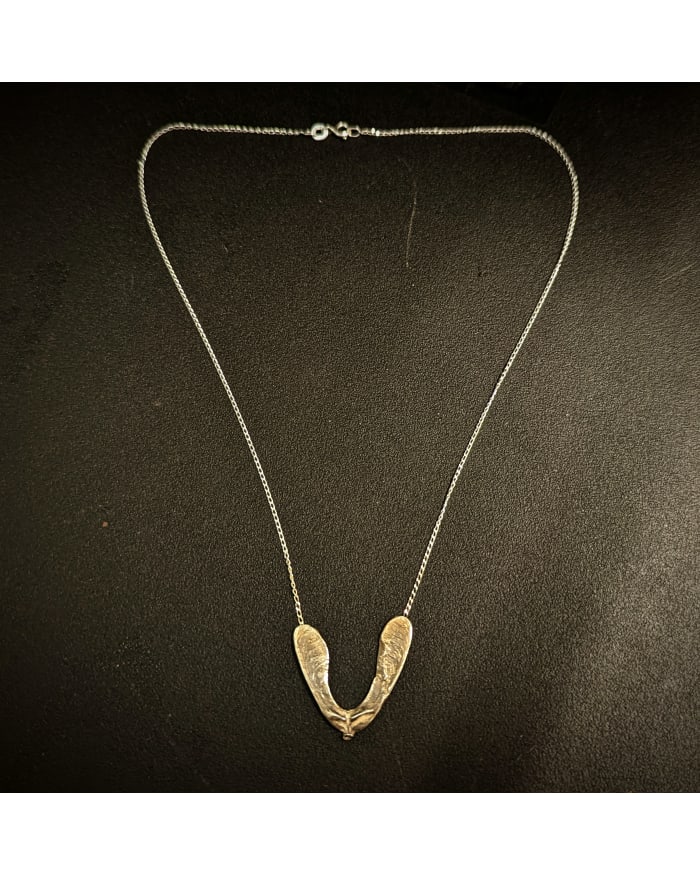 a gold necklace on a black surface