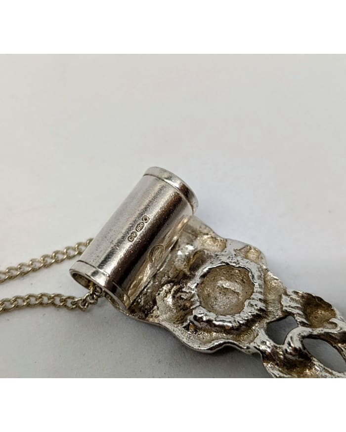 a silver object with a chain