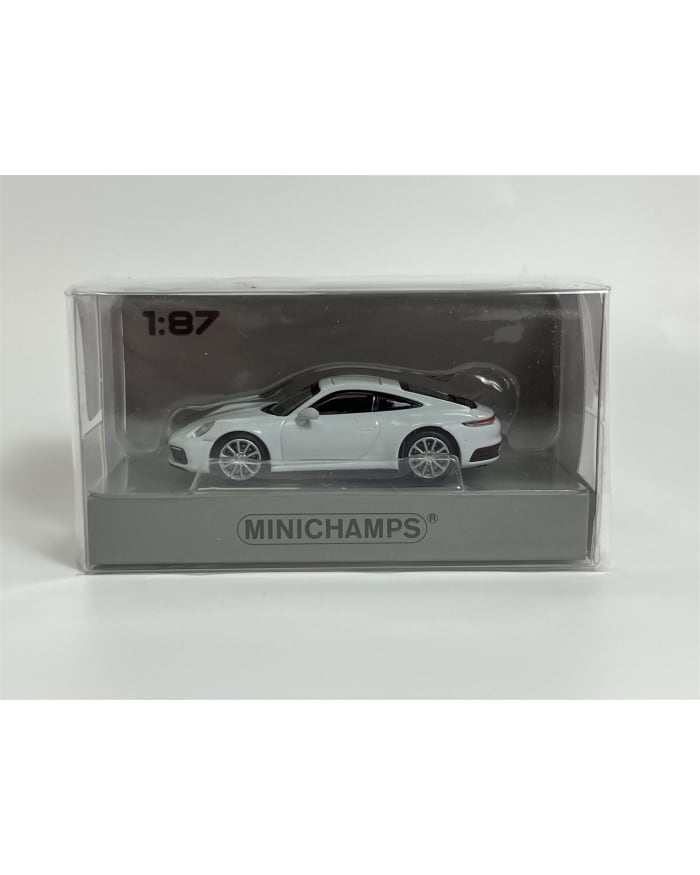 a white toy car in a plastic box