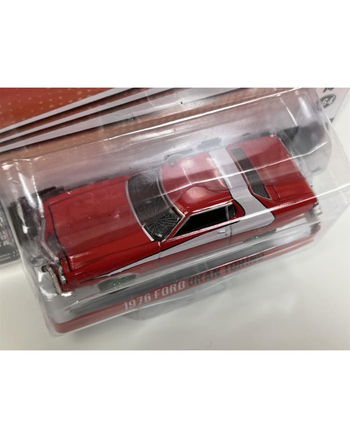 a red toy car in a plastic package