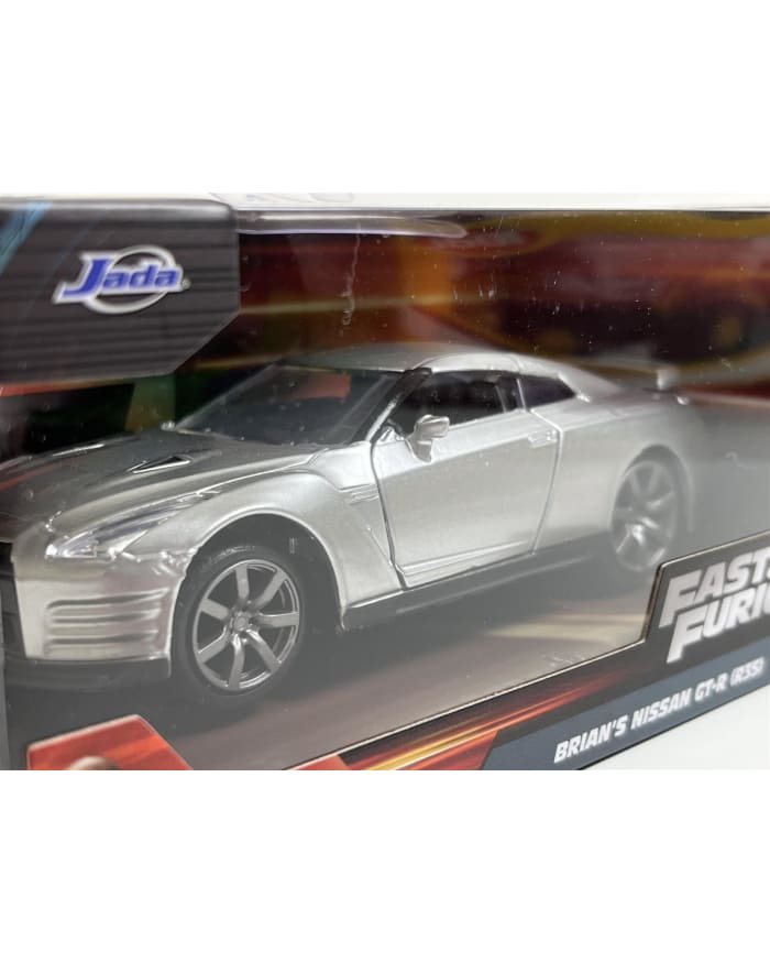 a silver toy car in a box